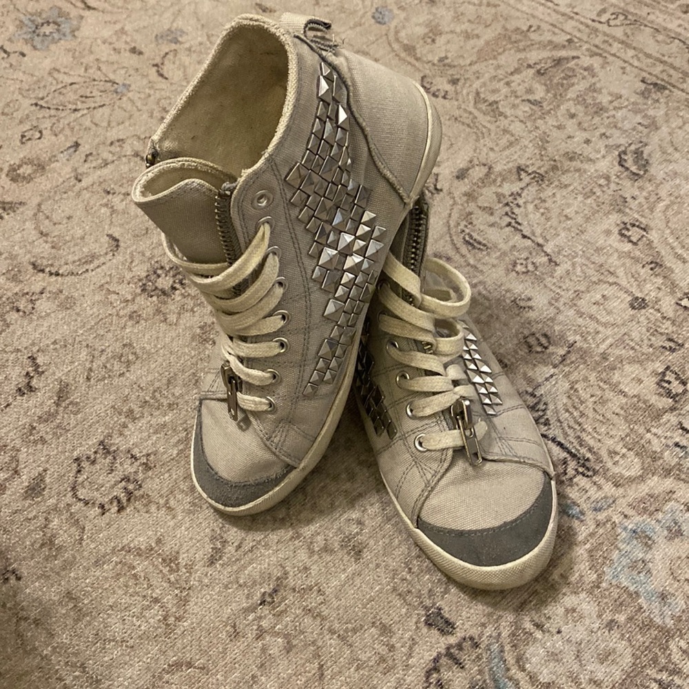 Gray sneaker high tops with studs.